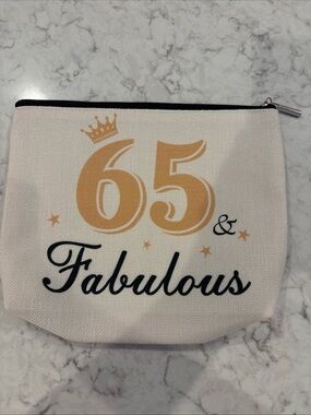 Tan canvas cosmetic makeup bag features gold crown & printed text 65 & Fabulous